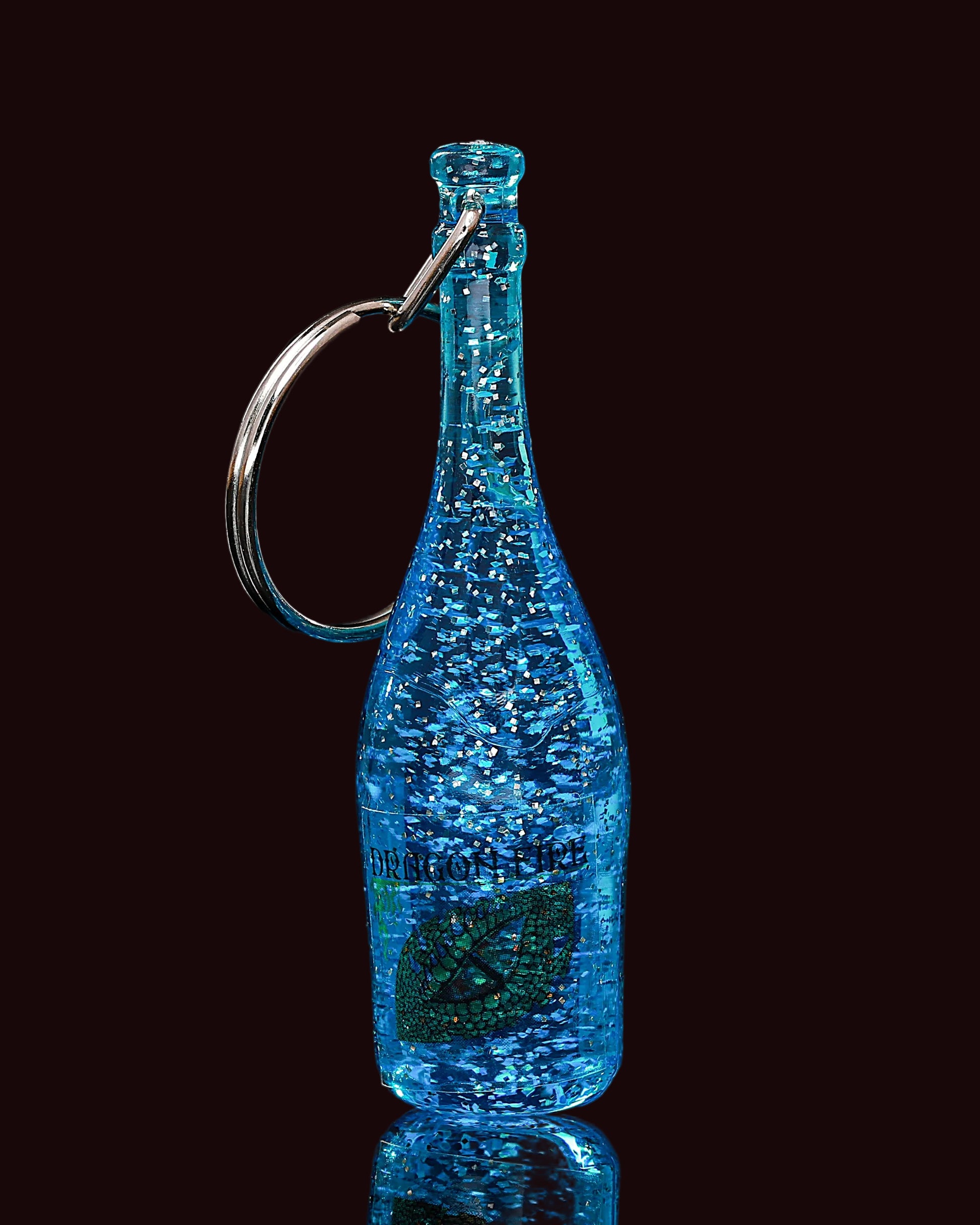 Blue bottle-shaped keychain with a metallic ring on a black background