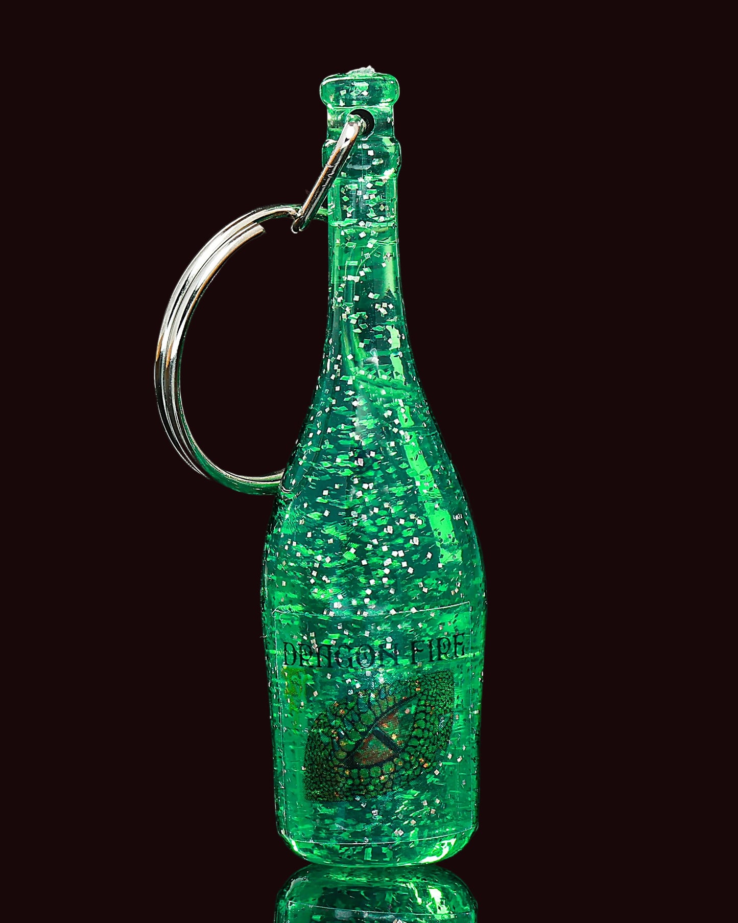 Green glittery bottle-shaped keychain on a black background