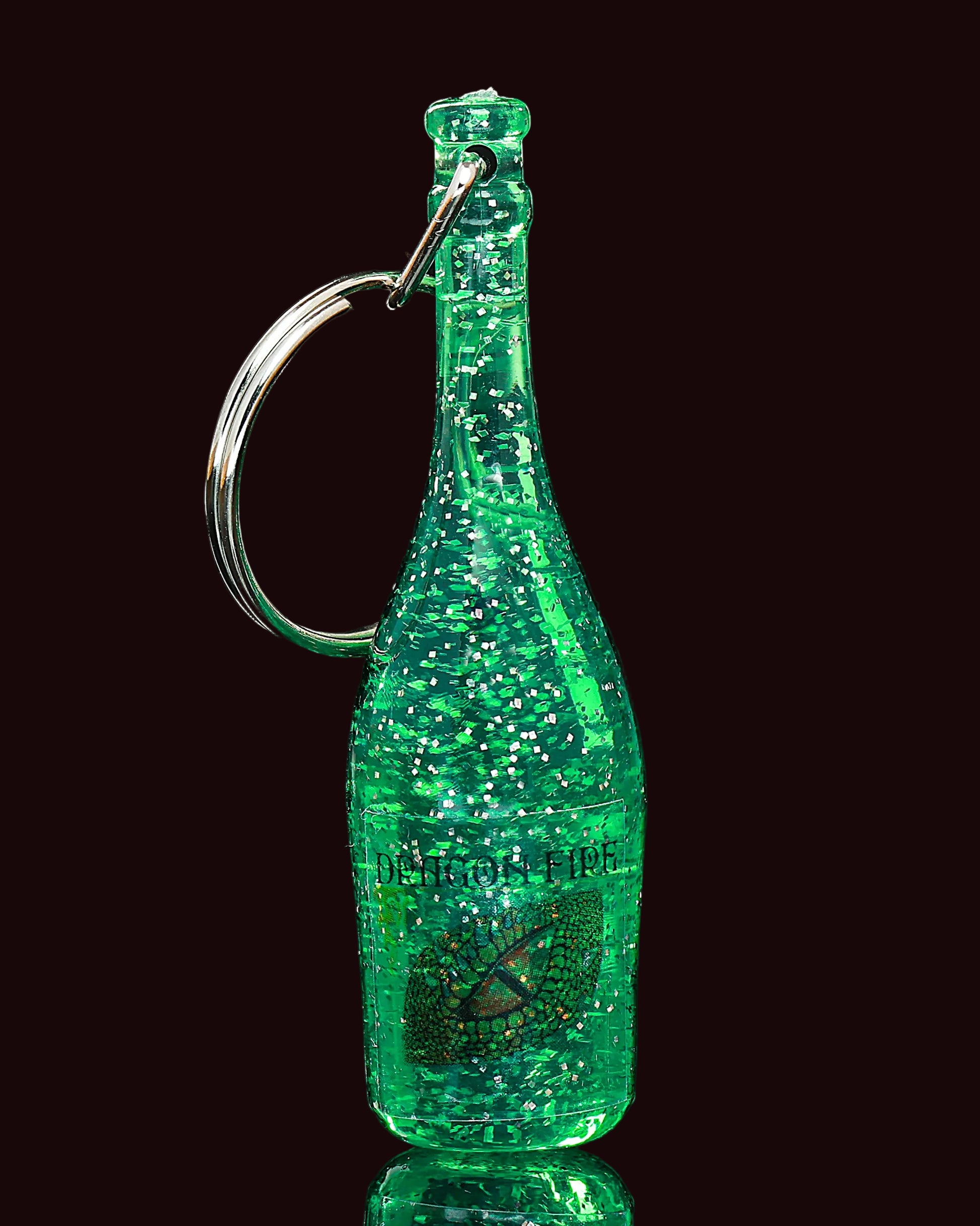 Green glittery bottle-shaped keychain on a black background