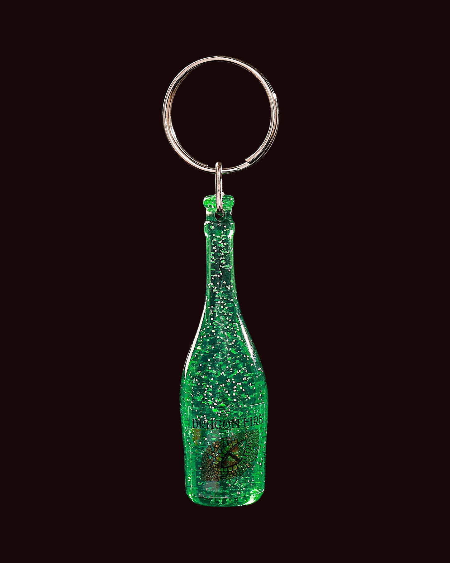 Green glittery bottle-shaped keychain on a black background